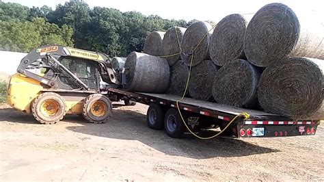 loading round bales with skid steer|hay and forage skid steer.